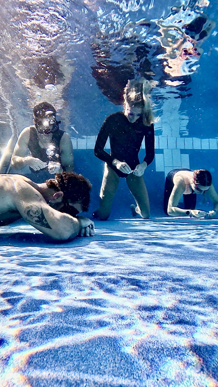A group working calmly together during an underwater exercise