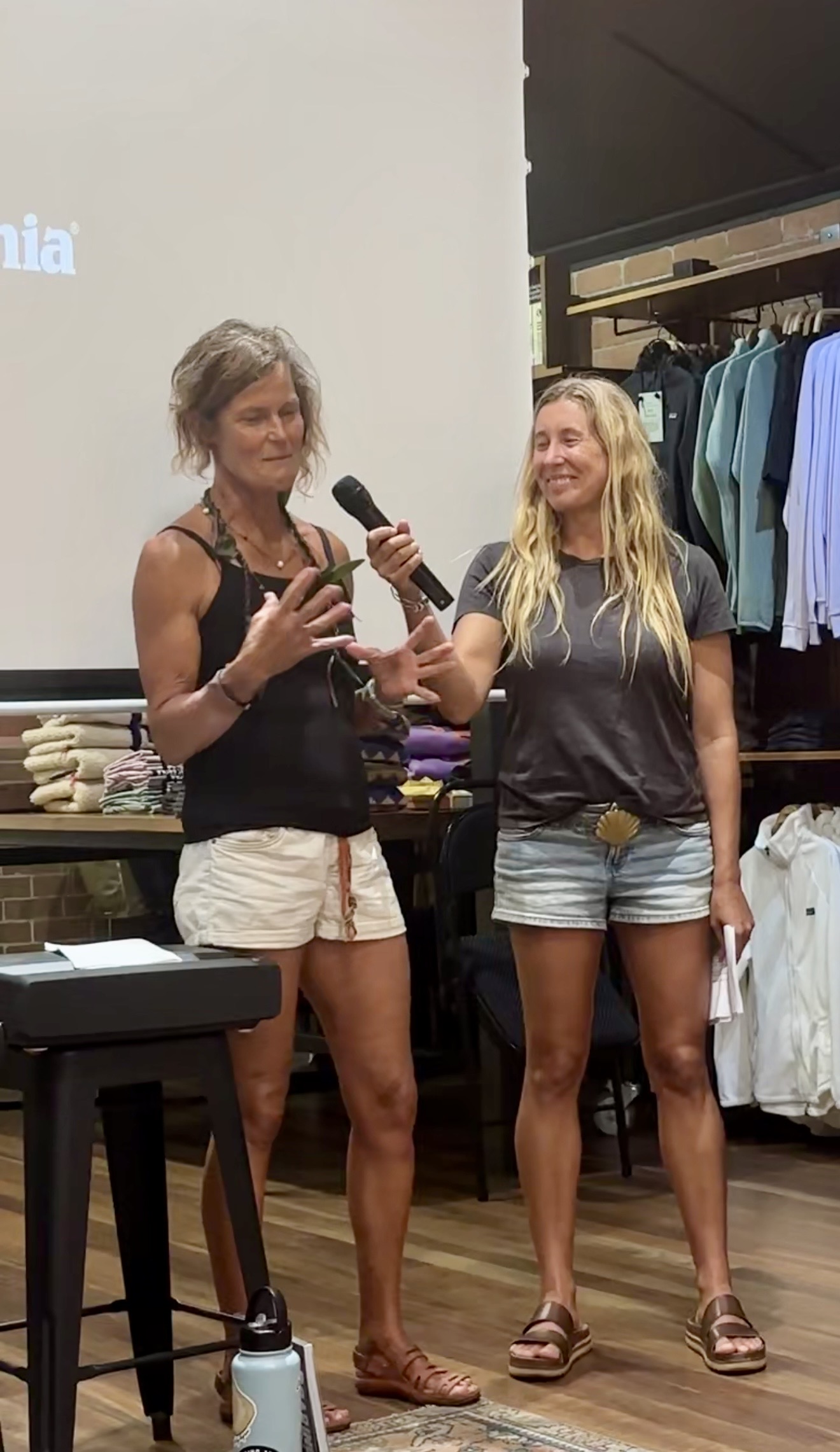 Heli speaking to an audience with a microphone at a Patagonia community event